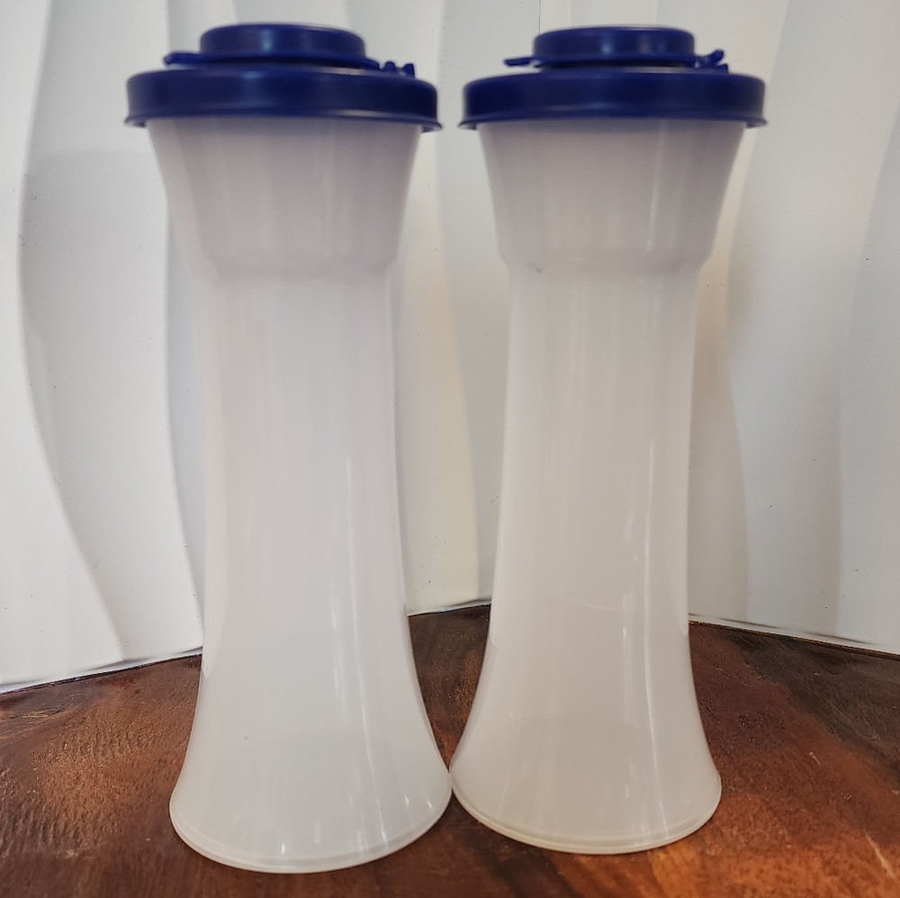Tupperware Large Hourglass salt and pepper shakers with blue lids.